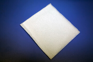 Blank paper napkin isolated on blue background with copy space . White napkin on blue background, many views of white napkins, blank mockup files .White Square Bar Napkin Isolated on blue Background .