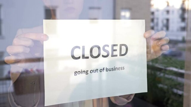 Closed Going Out Of Business Sign Placed At Store Front Window.