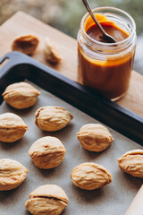 walnut biscuits and a jar of condensed milk, a recipe for making delicious homemade cookies. Copy space