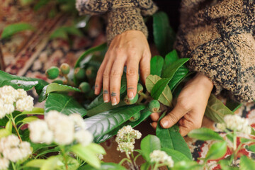 hands of a woman holding a bunch of flowers