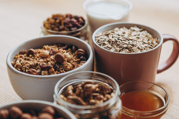 a delicious and crunchy oatmeal granola with honey, nuts, dried fruits and grains. Dynamic healthy food photography