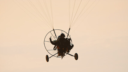 Paramotor Tandem Gliding And Flying In The Air. Copy space. High quality photo