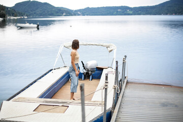 Fototapeta na wymiar Young woman on the boat