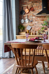 Serving for dinner on kitchen table. Warm kitchen background interior.