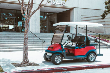 Red golf cart in front of business property