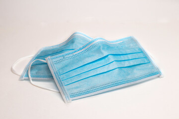 Fototapeta premium Covid-19 protective Medical mask, disposable surgical medical protective face mask covers the mouth and nose. Healthcare and Medical Concept white background.