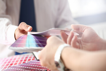 Employee refueling cartridge service holds magnifying glass in hand. Color print of pantone...
