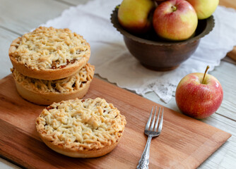 Pieces of delicious apple pie on wooden background
