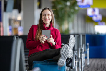 Young woman reading book waiting for flight
