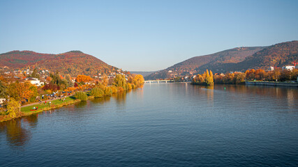 Panoramic view over stunning reddish sunset over the old town, castle and city bridges in Heidelberg during golden Autumn, Germany, fall