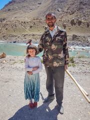 parent and child on the background of mountains 