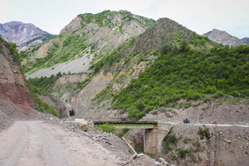 mountain road in the mountains with old bridge
