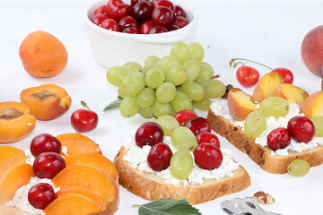 Diet fruit sandwiches with cottage cheese, peaches, grapes and cherries, a healthy breakfast with ingredients. The concept of healthy and natural food, lifestyle.