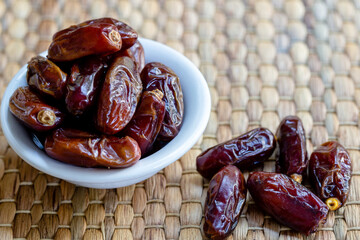 Fresh red dates (hurma) in bowl 