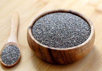 Healthy chia seeds in a wooden bowl on wooden table