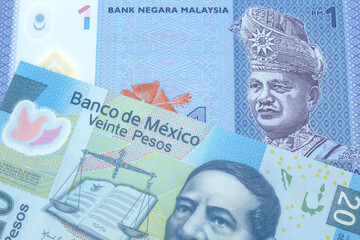 A blue, one ringgit Malaysian note close up in macro with a twenty peso note from Mexico
