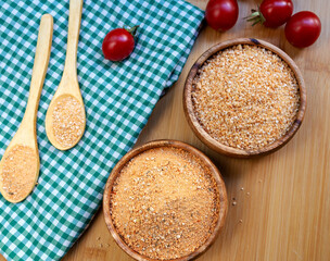 Turkish traditional tarhana (uncooked) and tomatoes on wooden background