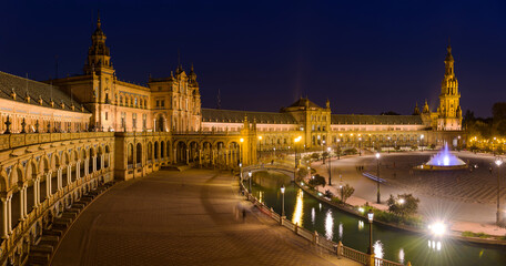 Spanish Square - A panoramic view of Spanish Square - Plaza de España, illuminated by many bright lights right after sunset. Seville. Andalusia, Spain.