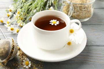 Composition with chamomile tea on white wooden background