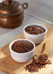 Siyez (siyazan) wheat bulgur in bowl and spoon on wooden background