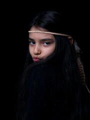  Portrait of a young little girl wearing headdress. 