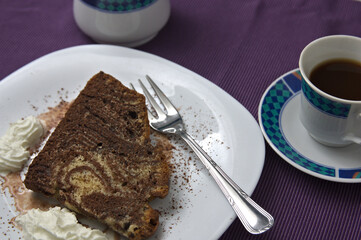 Portion of zebra or tiger cake and a cup of coffee