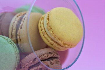 Closeup of some macarons with light pink background