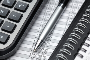 business office desk closeup - financial reports, analysis and accounting, set of documents, tables and graphs, various items for bookkeeping, calculator