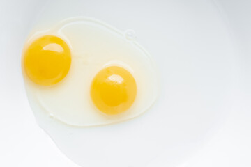 Two yolks in one chicken egg. Identical twins. Double egg. 