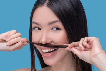Woman making moustaches from her long hair