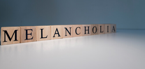 Text of melancholia from wooden cubes. psychological terms and health problems.