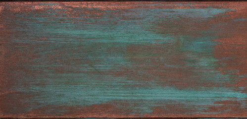 The texture of the copper background is covered with a green patina.