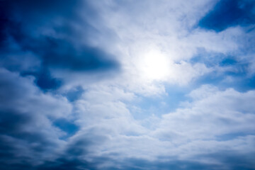 The background is blue sky and white soft clouds with bright sun. The light of the sun illuminates the white clouds. The concept of freedom.