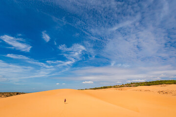 Happy woman on Red sand dunes in Vietnam