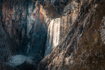 Fototapeta na wymiar Famous waterfall Boka in Julian Alps, Slovenia. Colorful rocks mountains, karst alpine landscape. Nature waterfall, one of the highest in Slovenia