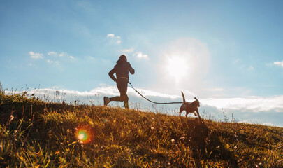 Man runing with his beagle dog at sunny morning. Healthy lifestyle and Canicross exercises jogging concept image.