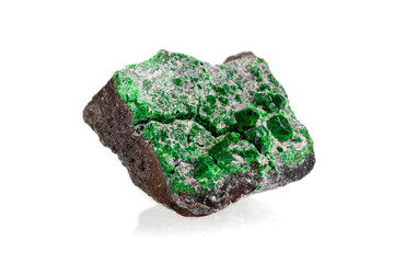 macro stone mineral uvarovite on a white background