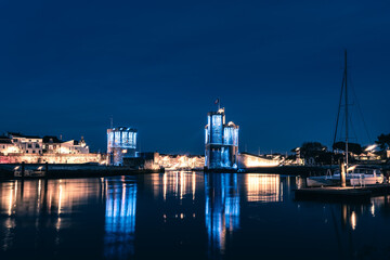 Panoramic view of the old harbor of La Rochelle at blue hour with its famous old towers