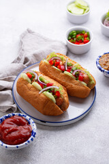 Hot dogs with sausage, sauces and vegetables