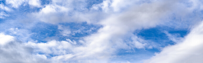 Fluffy clouds in bluet sky panoramic view. Climate, environment and good weather concept sky background panorama.