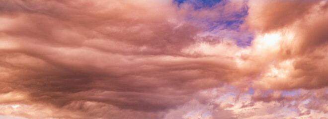 Summer sunset dranatic sky panorama with fleese clouds. Summer evening sky and weather concept background.