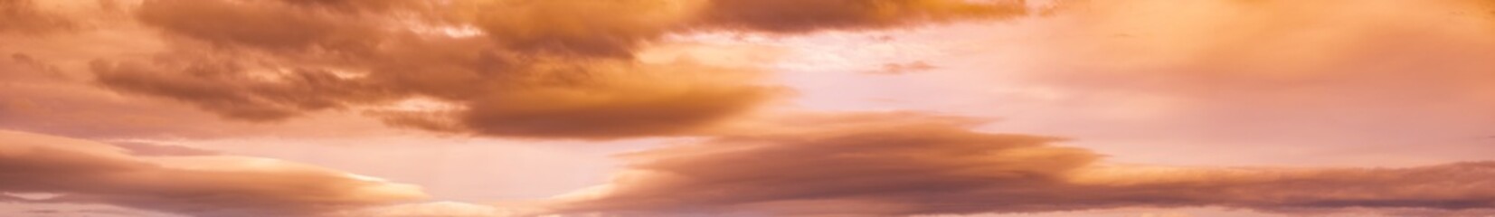 Summer sunset dranatic sky panorama with fleese clouds. Summer evening sky and weather concept high resolution background.