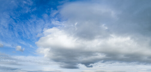 Obraz premium Fluffy clouds in bluet sky panoramic view. Climate, environment and good weather concept sky background panorama.