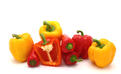 Composition of several sweet peppers and their halves of different colors on a light background. Natural product. Natural color. Close-up.
