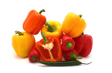 Composition of several sweet peppers and their halves of different colors on a light background. Natural product. Natural color. Close-up.