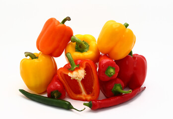 Composition of several sweet peppers and their halves of different colors on a light background. Natural product. Natural color. Close-up.