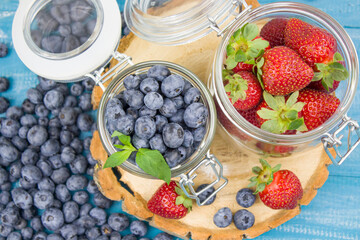 Fresh fruits. Healthy food. Mixed fruit, strawberries and blueberries, peaches. Studio photography of various fruits on an old wooden table. Organic healthy assorted fruits. Assortment of fresh fruit.