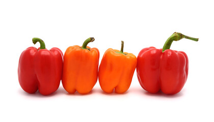 Two red and two orange ripe sweet peppers on a light background. Natural product. Natural color. Close-up.