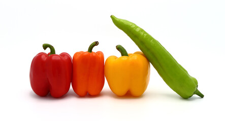 Four ripe sweet peppers on a light background. Red, yellow, green and orange. Natural product. Natural color. Close-up.