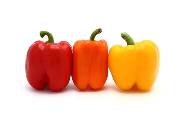 Three ripe sweet peppers of red, yellow and orange color on a light background. Natural product. Natural color. Close-up.